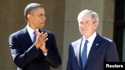 FILE - U.S. President Barack Obama applauds as former President George W. Bush arrives on stage at the dedication ceremony for the George W. Bush Presidential Center in Dallas, April 25, 2013. Taunted by Republicans to declare war on “radical Islamic terrorism,” Democrats are turning to an unlikely ally: George W. Bush.