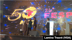 FILE - Rwandan President Paul Kagame and Burkinabe's ex-President Roch Marc Christian Kaboré present the trophy to laureate Joël Karekezi at FESPACO 2019 in Ouagadougou, Burkina, March 2, 2019.