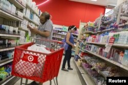 Customers shop in the pharmacy department of a Target store in the Brooklyn borough of New York June 15, 2015.