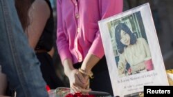 A photo of Lingzi Lu, a Chinese graduate student studying mathematics and statistics at Boston University, is seen outside the Marsh Chapel before a memorial for the third fatality of the Boston Marathon bombings in Boston, April 17, 2013. 