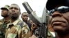 FILE - Guy Philippe, former police chief police, participates in a march into the city of Gonaives, Haiti, Feb. 19, 2004.