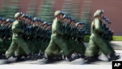 FILE - Russian paratroopers march during the celebrations of Paratroopers Day in the Red Square in Moscow, Russia, Aug. 2, 2017. The Russian military says major war games, the Zapad ("West") 2017 maneuvers, would include 13,000 Russian and Belarussian servicemen.