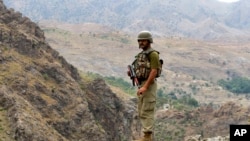 FILE - A Pakistan army soldier stands guard in the Pakistani tribal area of Khyber near the Torkham border post between Pakistan and Afghanistan, June 15, 2016.