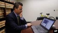 FILE - Robert Allard, an attorney for the family of Audrie Pott, watches a video of Pott at his office in San Jose, Calif., Friday, April 12, 2013. Allard said that Pott committed suicide after she was sexually assaulted by three of her friends and a photo surfaced online.