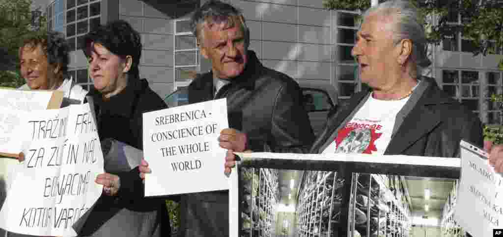 Bosnian Muslim Munira Subasic, right, takes part in a small demonstration of relatives of the Bosnian war dead outside the Yugoslav War Crimes Tribunal in The Hague, Netherlands, May 16, 2012.