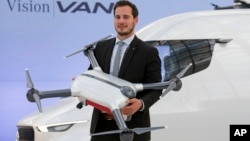 FILE - Frieder Soenning, employee of the Daimler AG, presents the Matternet Drone-equipped delivery van Mercedes Vision Van at the International Transport Forum 2017 in Leipzig, Germany, May 31, 2017. 