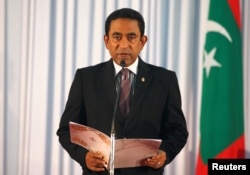 FILE - Abdulla Yameen takes his oath as the president of Maldives during a swearing-in ceremony at the parliament in Male, Nov. 17, 2013.