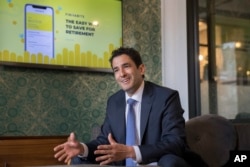 Carlos Garcia, founder and CEO of Finhabits, speaks during an interview with The Associated Press in New York, May 22, 2018.