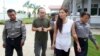 FILE - Singaporean journalist Lau Hon Meng, center left, and Malaysian journalist Mok Choy Lin, both accused of flying drones illegally over parliament buildings, are escorted during their trial at a court in Naypyitaw, Myanmar, Nov. 10, 2017.