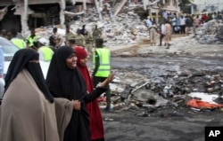 Somali women react at the scene of Saturday's blast, in Mogadishu, Somalia, Oct. 15, 2017.