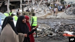 Somali women react at the scene of Saturday's blast, in Mogadishu, Somalia, Oct. 15, 2017.