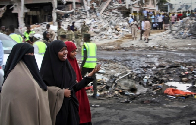 FILE - Somali women react at the scene of a deadly blast in Mogadishu, Somalia, Oct. 15, 2017.