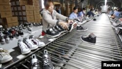 Workers assemble shoes in a shoe factory near Hanoi. Vietnam is seeking to expand its manufacturing sector as a high tech supplier.