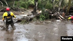 Emergency personnel search through debris and mud flow after a mudslide in Montecito, California, U.S. in this still photo taken from video provided by the Santa Barbara County Fire Department, Jan. 9, 2018.