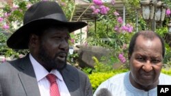 FILE - South Sudan President Salva Kiir, left, along with former president of Mali, Alpha Oumar Konaré, the AU High Representative for South Sudan, answer questions at the presidential palace in Juba, South Sudan, July 14, 2016.