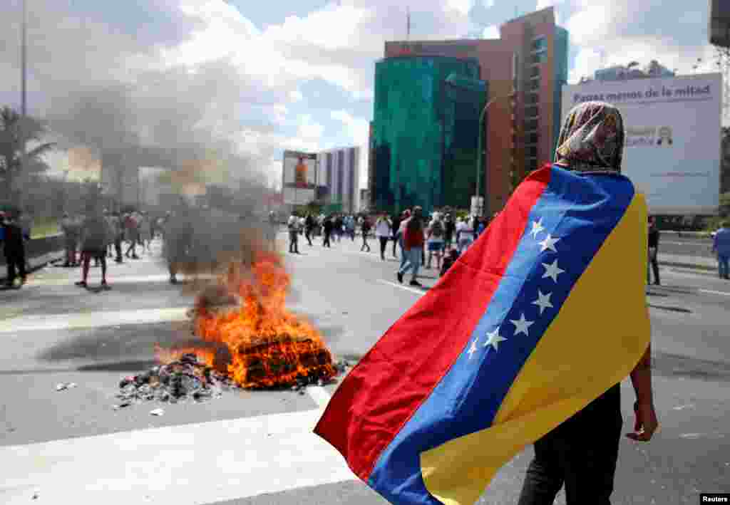 Protesters clash with riot police during a rally to demand a referendum to remove Venezuela's President Nicolas Maduro in Caracas, Venezuela.