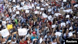 Protesters hold posters and shout as they protest in support of Zaw Lin and Win Zaw Htun, two Myanmar migrant workers in Thailand, in front of the Thai embassy in Yangon, Dec. 25, 2015.