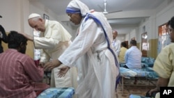 Pope Francis greets and blesses one of the guests of the Mother Teresa House in the Dhaka's Tejgaon neighborhood, Bangladesh, Dec. 2, 2017.