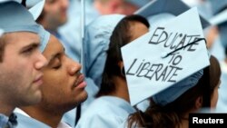 FILE - A graduate from Columbia University's School of Engineering sleeps during the university's commencement ceremony in New York, May 16, 2012. (REUTERS/Keith Bedford)
