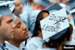 FILE - A graduate from Columbia University's School of Engineering sleeps during the university's commencement ceremony in New York, May 16, 2012. (REUTERS/Keith Bedford)