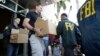 Federal agents load a van with boxes of evidence taken from the headquarters of the Confederation of North, Central America and Caribbean Association Football (CONCACAF,) Wednesday, May 27, 2015, in Miami Beach, Fla.