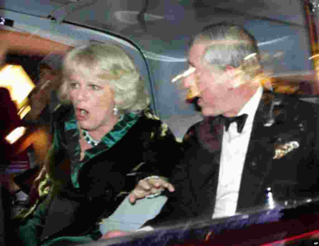 Britain's Prince Charles and Camilla, Duchess of Cornwall, react as their car is attacked by angry protesters in London, Thursday, Dec. 9. (Matt Dunham/AP)