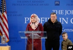 FILE - Fatema, left, speaks beside her husband, Abdullah, and her son Ayham, 5, during the John F. Kennedy Profile in Courage Award ceremony at the John F. Kennedy Presidential Library in Boston, May 1, 2016. The family, whose first names only are given for security concerns, are Syrian refugees who were resettled in Connecticut by Gov. Dannel P. Malloy after being turned away by another state. Malloy received the Profile in Courage Award for his vocal support of refugee resettlement.