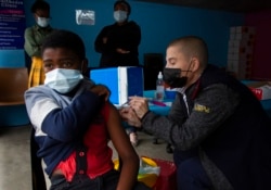 A boy gets vaccinated against COVID-19 at a site near Johannesburg, Dec. 8, 2021.