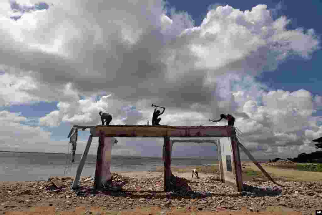 Bangladeshi men work on a structure on the banks of the River Padma in Munshiganj on the outskirts of Dhaka. 