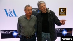 Band members Nick Mason (L) and Roger Waters pose for photographers at a media event to promote "The Pink Floyd Exhibition: Their Mortal Remains," which will open in May 2017, in London, Feb. 16, 2017. 