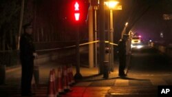 Police officers guard an intersection near the Diaoyutai State Guesthouse where top North Korean leaders have stayed on previous trips to Beijing, March 26, 2018.