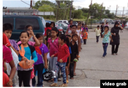 FILE - Burmese refugee children line up during a toy drive in Houston, Texas, in this undated photo.