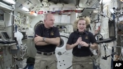 In this image made from video provided by NASA, astronaut Kate Rubins, right, speaks during an interview aboard the International Space Station on July 13, 2016. 