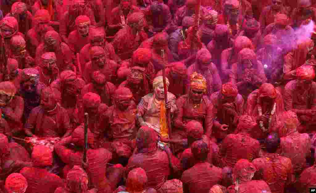 Indian Hindu devotees smeared with colors sing at the Nandagram temple, famous for Lord Krishna and his brother Balram, during Lathmar holy festival, in Nandgaon.