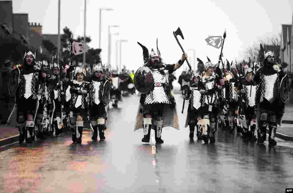 Participants dressed as Vikings prepare to participate in the annual Up Helly Aa festival in Lerwick, Shetland Islands, northeast of Britain. Up Helly Aa celebrates the influence of the Scandinavian Vikings in the Shetland Islands and culminates with up to 1,000 &#39;guizers&#39; (men in costume) throwing flaming torches into their Viking longboat and setting it alight later in the evening.