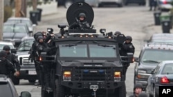 Police patrol through a neighborhood in Watertown, Mass., while searching for a suspect in the Boston Marathon bombings.