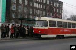 People queue up to board a tram in Pyongyang, Feb. 2, 2019. North Korea is upgrading its overcrowded mass transit system in a campaign meant to show leader Kim Jong Un is raising the country's standard of living.