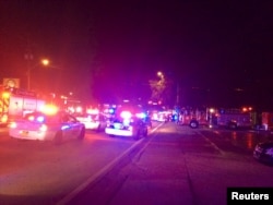 Police cars and fire trucks are seen outside the Pulse night club where police said a suspected gunman left multiple people dead and injured in Orlando, Florida, June 12, 2016.