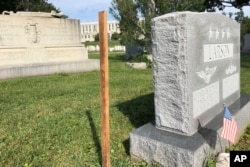 A wooden spike marks the spot, Aug. 25, 2018 where Sen. John McCain, R-Ariz., will be buried on the grounds of the U. S. Navel Academy in Annapolis, Md.