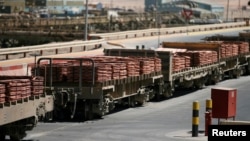 FILE - A train loaded with sheets of copper cathode at the copper cathode plant, is seen at BHP Billiton's Escondida, the world's biggest copper mine, in Antofagasta, northern Chile.