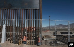 FILE - Work continues on a taller fence in the Mexico-US border area separating the towns of Anapra, Mexico, and Sunland Park, New Mexico, Jan. 25, 2017. President Donald Trump's proposed budget envisions $44.1 billion for homeland security, inlcuding $2.6 billion to start his much promised border wall and an extra $1.5 billion for Immigration and Customs Enforcement.