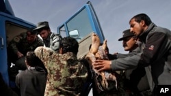 Afghan soldiers remove dead passenger from truck after U.S. forces shot two passengers and injured another on road between Kabul and Bagram, March 11, 2013.
