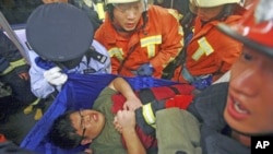 Rescue workers evacuate an injured man from a train after a subway train collision near Yu Yuan Garden station in Shanghai, China, September 27, 2011.