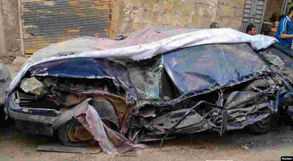 A destroyed car along a street in Deir Al Zour, May 15, 2012.