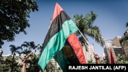 FILE: People hold Biafra flags in a demonstration in Durban, South Africa, on May 30, 2019 during a Freedom March for Biafra by the Indigenous People of Biafra (IPOB) to mark the anniversary of the 1967 declaration of independence that sparked a brutal 30-month civil war.