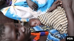 Yayicho Koko, who has been living off leaves in the bush, with her baby. (Hannah McNeish for VOA)