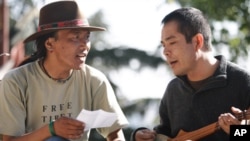The filmmaker, Ngawang Choephel (right) and a friend, prepare a traditional song for 'Tibet in Song.'