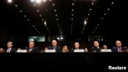 Left to right, Federal Bureau of Investigation (FBI) Director Christopher Wray; Central Intelligence Agency (CIA) Director Mike Pompeo; Director of National Intelligence (DNI) Dan Coats; Defense Intelligence Agency Director Robert Ashley; National Security Agency (NSA) Director Michael Rogers; and National Geospatial Intelligence Agency Director Robert Cardillo testify before a Senate Intelligence Committee hearing on "Worldwide Threats" on Capitol Hill in Washington, Feb. 13, 2018. 
