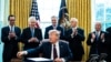 Treasury Secretary Steven Mnuchin, left, Vice President Mike Pence, second from right, and Republican lawmakers applaud President Donald Trump during a signing ceremony for H.R. 748, the CARES Act, at the White House, March 27, 2020.