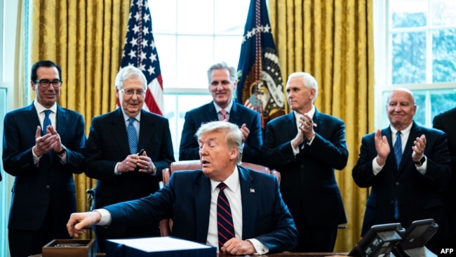 WASHINGTON, DC - MARCH 27: (L-R) Treasury Secretary Steven Mnuchin, Senate Majority Leader Mitch McConnell (R-KY), House Minority Leader Kevin McCarthy (R-CA), Vice President Mike Pence and Rep. Kevin Brady (R-TX) applaud U.S. President Donald Trump…